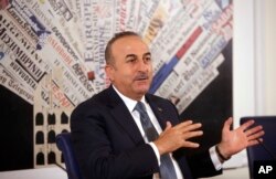 Turkish Foreign Minister Mevlut Cavusoglu talks at the Foreign Press Club, in Rome, Nov. 23, 2017.