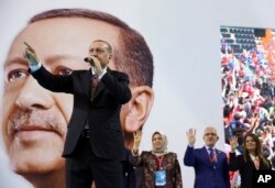 FILE - Turkey's President Recep Tayyip Erdogan gestures as he speaks during a rally of his ruling Justice and Development Party's supporters, in Mersin, southern Turkey, March 10, 2018.