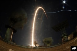 In this photo taken with long time exposure the Soyuz-FG rocket booster with Soyuz MS-03 space ship carrying a new crew to the International Space Station blasts off at the Russian leased Baikonur cosmodrome, Kazakhstan, Nov. 18, 2016.
