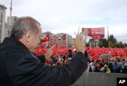 Turkish President Recep Tayyip Erdogan salutes the crowd of supporters in his hometown of Rize, on the Black Sea coast of Turkey, Oct. 15, 2016. Erdogan said Turkey was moving into Dabiq, Syria, and would declare a "terror-free safe zone" in the region.