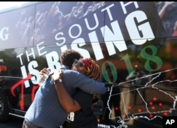 Black Voters Matter co-founder LaTosha Brown, right, gets a hug from a well wisher before departing on The South Is Rising Tour 2018 on Aug. 22, 2018, in Stockbridge, Ga.