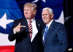 FILE - Republican presidential candidate Donald Trump, points toward Republican vice presidential candidate Indiana Gov. Mike Pence after Pence's acceptance speech during the third day session of the Republican National Convention in Cleveland.