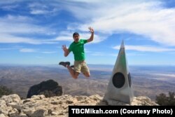 Mikah Meyer celebrates his final national park stop in Texas on Guadalupe Peak, also known as Signal Peak, the highest point in the Lone Star State.