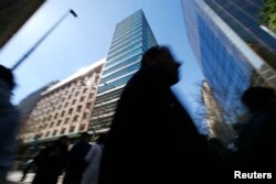 People walk past a commercial area in downtown Santiago, Aug. 25, 2014.