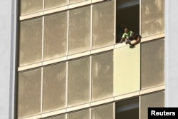 Workers board up a broken window at the Mandalay Bay Resort and Casino, where shooter Stephen Paddock conducted his mass shooting along the Las Vegas Strip, in Las Vegas, Nevada, Oct. 6, 2017.