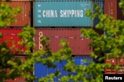 FILE - Shipping containers are stacked at the Paul W. Conley Container Terminal in Boston, Massachusetts, May 9, 2018.