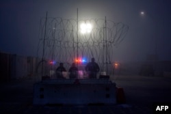 Members of the U.S. Border Police guard the international bridge in Texas, as seen from Piedras Negras, Coahuila state, Mexico, Feb. 6, 2019.