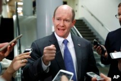 FILE - Sen. Chris Coons, D-Del., speaks to reporters at the Capitol in Washington, May 18, 2017.