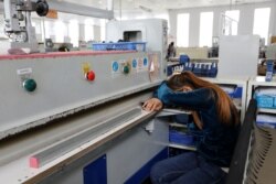 FILE - A worker has a nap at Complete Honour Footwear Industrial, a footwear factory owned by a Taiwan company, in Kampong Speu, Cambodia, July 4, 2018.