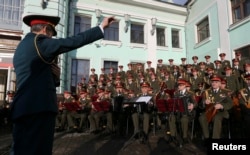 FILE - Singers and orchestra members of Red Army Choir, also known as the Alexandrov Ensemble, perform in Moscow, Apr. 20, 2016.