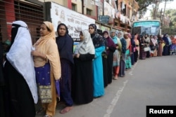 Women stand in a line at a voting center to cast their ballot during the general election in Dhaka, Bangladesh, Dec. 30, 2018.