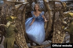 Cinderella wears a beautiful gown as steps out of her coach.