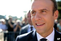 French President Emmanuel Macron meets people after voting in the final round of parliamentary elections, in the northern seaside town of Le Touquet, France, June 18, 2017.