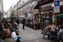 Customers drink beers at cafe terraces in Paris, May, 19, 2021. Cafe and restaurant terraces reopened Wednesday after a six-month coronavirus shutdown deprived residents of the essence of French lifestyle — sipping coffee and red wine with friends.(AP Photo)