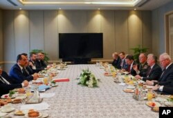 White House National Security Adviser John Bolton, 2nd right, and senior adviser to Turkish President Recep Tayyip Erdogan, Ibrahim Kalin, left, head their delegations during a meeting at the Presidential Palace in Ankara, Turkey, Jan. 8, 2019.
