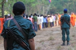 In this file photo, Cambodian armed police monitor last year's tree blessing ceremony in Prey Lang protected forest. (Courtesy photo of Licadho)