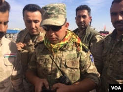 Peshmerga soldiers prepare to leave the battles surrounding Mosul and head to Kirkuk to re-enforce local security forces after Friday Islamic State attacks near Hassan Sham, Kurdistan, Iraq, Oct. 21, 2016. (Photo: H. Murdock / VOA)