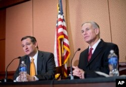 FILE - Then-Republican presidential candidate Sen. Ted Cruz, R-Texas, left, and Texas Gov. Greg Abbott speak about the resettlement of Syrian refugees in the U.S., during their joint news conference on Capitol Hill in Washington, Dec. 8, 2015.