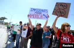 Immigrant rights advocates protest near the U.S.-Mexico border over a visit by U.S. Attorney General Jeff Sessions and Secretary of Homeland Security John Kelly in San Ysidro, a district of San Diego, California, April 21, 2017.