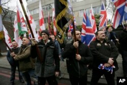 FILE - Members of Britain First, a far-right nationalist political party, protest across the street from London Central Mosque during prayers in Regent's Park, London, April 3, 2015.