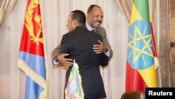 Ethiopian Prime Minister Abiy Ahmed and Eritrean President Isaias Afwerk embrace at the declaration signing in Asmara, Eritrea, July 9, 2018, in this photo obtained from social media. (Ghideon Musa Aron Visafric/via Reuters)