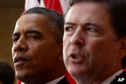 President Barack Obama and FBI Director James Comey participate in the installation ceremony for Comey as FBI director, at FBI Headquarters in Washington, Oct. 28, 2013.