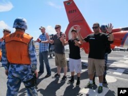 People's Liberation Army sailors pat down U.S. Coast Guardsmen playing the role of merchant mariners aboard the Coast Guard cutter Waesche off Hawaii, July 16, 2014. Chinese sailors boarded the Coast Guard cutter Waesche for a drill checking cargo as part of Rim of the Pacific exercises.