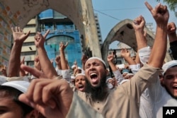 FILE - Bangladeshi activists of various Islamic political groups and other Muslims shout slogans after Friday prayers during a protest in Dhaka, Bangladesh, March 25, 2016.