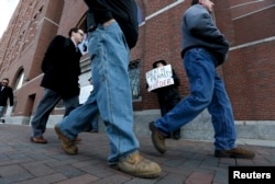 South Boston resident Joe Kebartas, holding a sign reading "Death Penalty is Murder," demonstrates outside the federal courthouse where Boston Marathon bombing suspect Dzhokhar Tsarnaev has been convicted on all 30 counts, April 8, 2015.