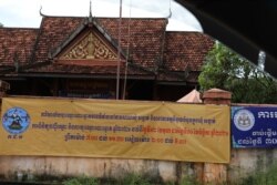 រូបឯកសារ៖ ផ្ទាំង​ក្រណាត់​ផ្សព្វផ្សាយ​ពី​ការពិនិត្យ​បញ្ជី​ឈ្មោះ​ និង​ការចុះ​ឈ្មោះ​បោះឆ្នោត​ឆ្នាំ​២០២១ នៅ​សាលា​សង្កាត់​ត្រើយកោះ ក្នុង​ខេត្ត​កំពត​នៃ​ប្រទេស​កម្ពុជា។ រូបថត​កាល​ពី​ដើម​ខែ​តុលា ឆ្នាំ​២០២១។ (ស៊ុន ណារិន/វីអូអេ)