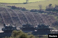 FILE - Turkish Army tanks are seen near the Turkish-Syrian border in Kilis province, Turkey, Jan. 31, 2018.