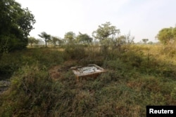 FILE - An open toilet is seen in a field in Gorba in the eastern Indian state of Chhattisgarh, India, Nov. 16, 2015.