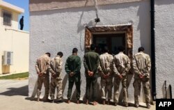 Fighters loyal to military commander Khalifa Haftar, reportedly minors, are imprisoned by forces from the U.N.-backed Government of National Accord (GNA) in Tripoli's suburb of Ain Zara, April 11, 2019.