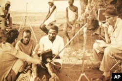 Hugh Tracey (left) and his son, Andrew, recording musicians on one of their many fieldtrips