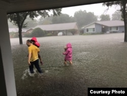 A family evacuates from the Westbury neighborhood of Houston, Aug. 27, 2017. (Photo courtesy of Paul Trinh)