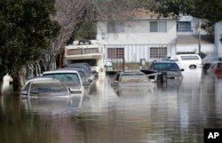 Submerged automobiles are shown on flooded Nordale Avenue in San Jose, California, Feb. 22, 2017.