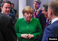 Luxembourg Prime Minister Xavier Bettel, German Chancellor Angela Merkel and European Council President Donald Tusk attend a European Union leaders informal summit in Brussels, Belgium, Feb. 23, 2018.