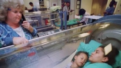 A mother and child poisoned by carbon monoxide are treated in an oxygen-rich hyperbaric chamber at a hospital in Massachusetts