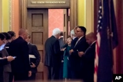 FILE - Republican senators gather to meet with Senate Majority Leader Mitch McConnell on the Repblican effort to overhaul the U.S. tax code, on Capitol Hill, in Washington, Dec. 1, 2017. A vote on the bill could be held as early as next week.