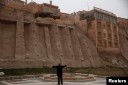 An ethnic Uighur stetches during his morning exercise outside the old town in Kashgar, Xinjiang Uighur Autonomous Region, China, March 23, 2017.