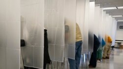 Voters fill out their ballot during early voting at the Cuyahoga County Board of Elections, Tuesday, Oct. 6, 2020, in Cleveland. (AP Photo/Tony Dejak)