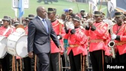FILE - DRC President Joseph Kabila inspects an honor guard during anniversary celebrations of the country's independence from Belgium in Kindu, DRC, June 30, 2016. Kabila's opponents accuse him of stalling a yet unscheduled poll to hold on to power, a charge he denies.