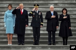President Donald Trump, first lady Melania Trump, Maj. Gen. Bradley Becker, Vice President Mike Pence and his wife Karen Pence, review troops on the East Front of the Capitol in Washington, Jan. 20, 2017, during the presiudential inauguration ceremony.