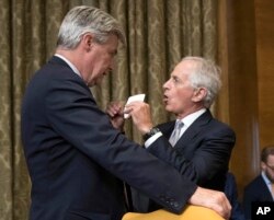 Senate Budget Committee members Sen. Sheldon Whitehouse, D-R.I., left, and Sen. Bob Corker, R-Tenn., talk before the start of a Senate Budget Committee hearing to consider fiscal 2018 reconciliation legislation on Capitol Hill in Washington, Nov. 28, 2017