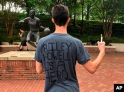 David Belnap, a sophomore at the University of North Carolina at Charlotte, displays a T-shirt in support of Riley Howell in Charlotte, N.C., May 1, 2019.