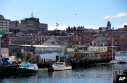 FILE -- Fishing boats are tied up at a wharf on the waterfront in Portland, Maine, March 11, 2016.