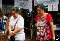 Family members walk near a cave where where 12 boys and their soccer coach have been trapped since June 23, in Mae Sai, Chiang Rai province, in northern Thailand, July 6, 2018.