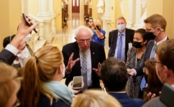 FILE - Senator Bernie Sanders (I-VT) speaks to reporters at the U.S. Capitol building on Capitol Hill in Washington, Sept. 30, 2021.