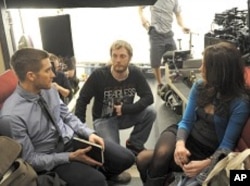 Director Duncan Jones, center, with Jake Gyllenhaal and Michelle Monaghan on the set of "Source Code"