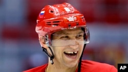 Russia forward Alexander Ovechkin laughs with teammates during a training session at the 2014 Winter Olympics, Feb. 10, 2014, in Sochi, Russia.